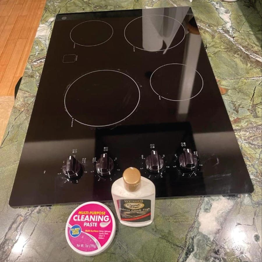 Top Cleaning cleaning products on a freshly polished cooktop